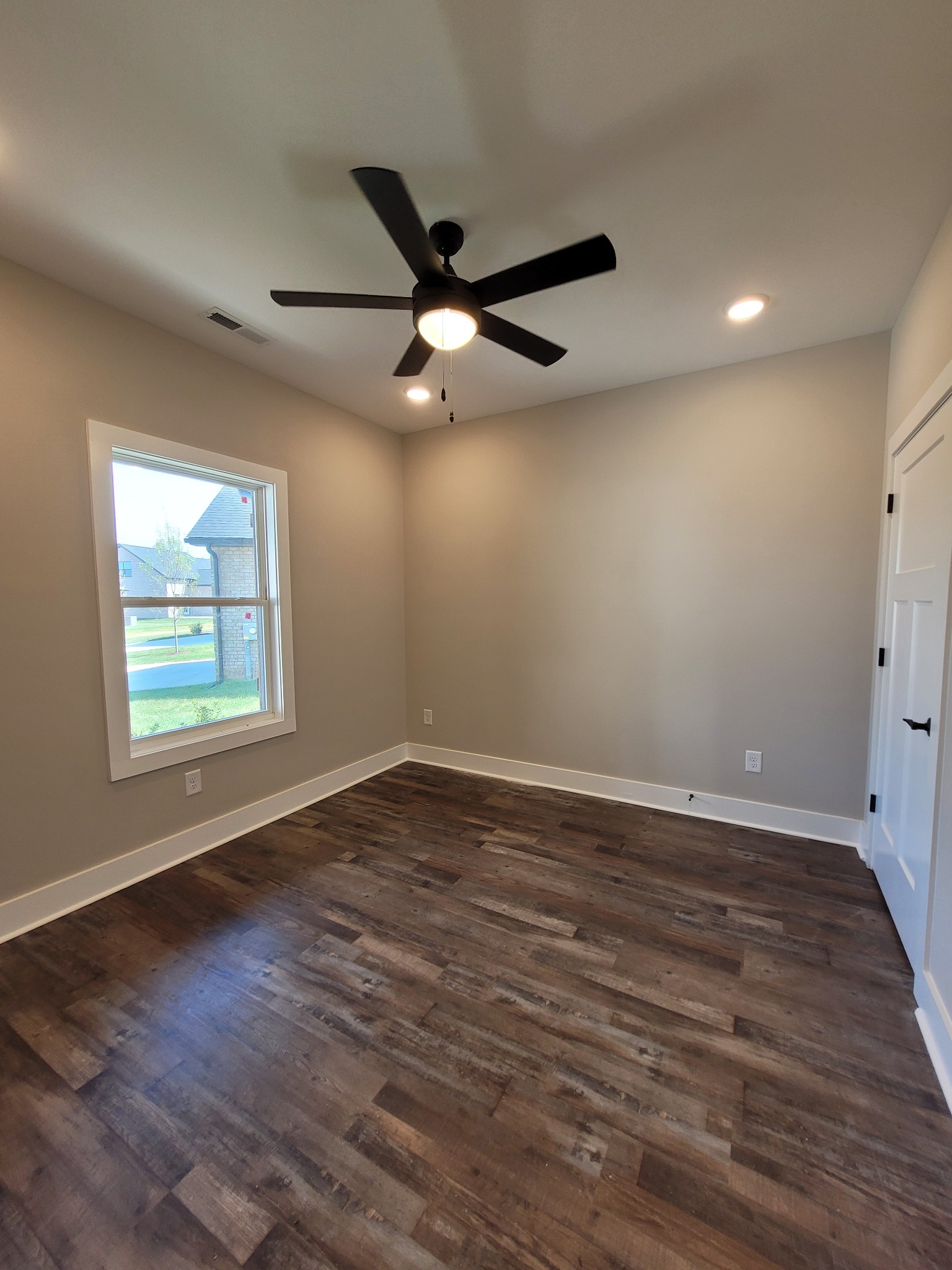 404 Cottage Lane Dickson, TN 37055 - Photo 13 of 35 an empty room with wooden floor ceiling fan and windows