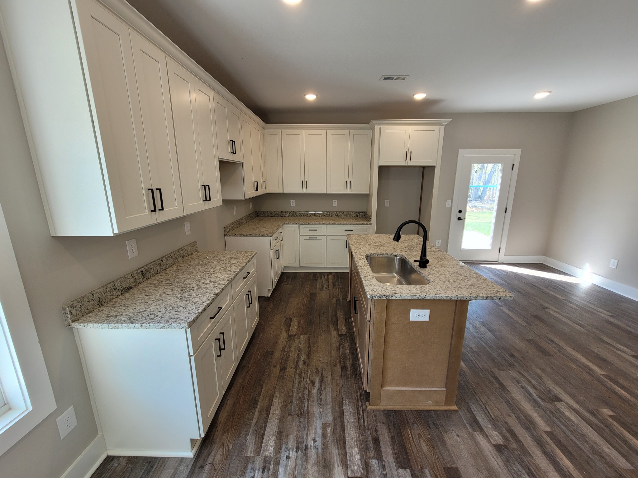 404 Cottage Lane Dickson, TN 37055 - Photo 7 of 35 a large kitchen with stainless steel appliances granite countertop a lot of counter space and wooden floors