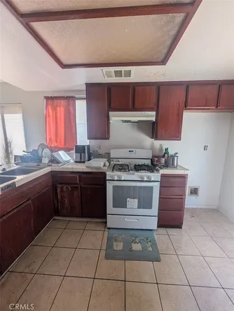 a kitchen with a stove top oven cabinets and appliances