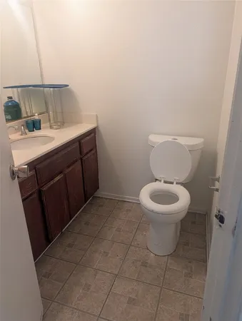 a bathroom with a toilet a sink and mirror