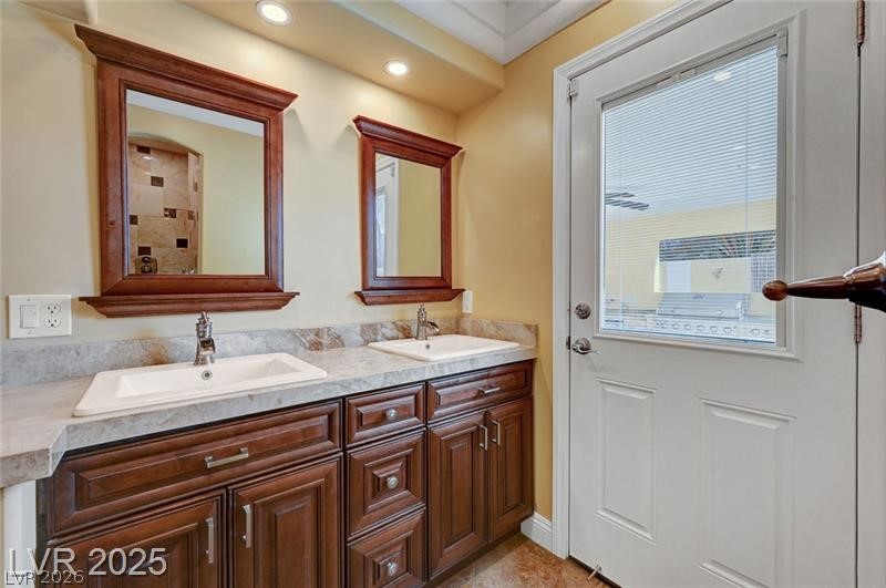 2410 Doherty Way Henderson, NV 89014 - Photo 47 of 63 Full bathroom with double vanity and recessed lighting