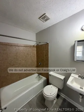 a bathroom with a toilet a sink and a bathtub