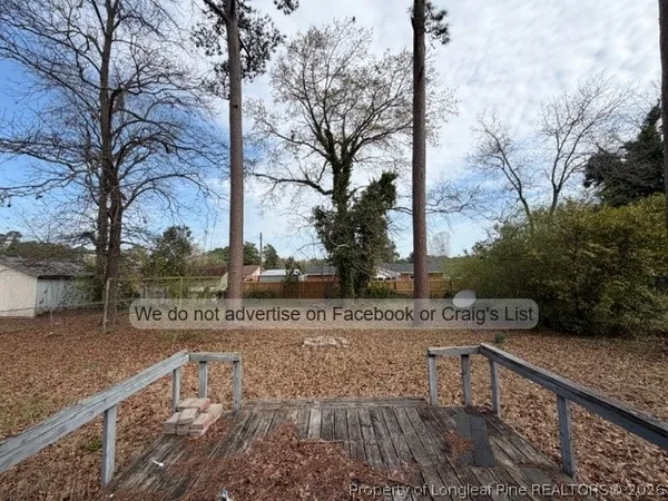a view of a street with wooden fence