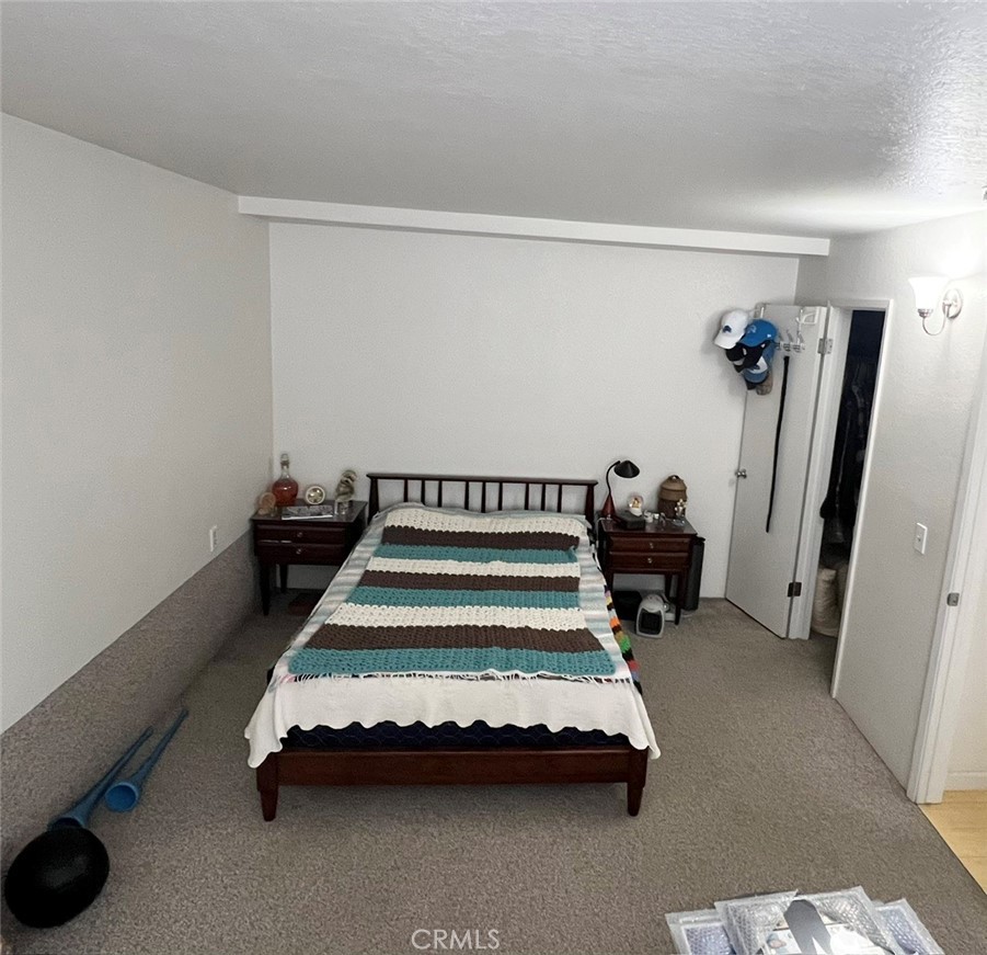 375 Surf Street Morro Bay, CA 93442 - Photo 17 of 25 a bedroom with furniture and a potted plant