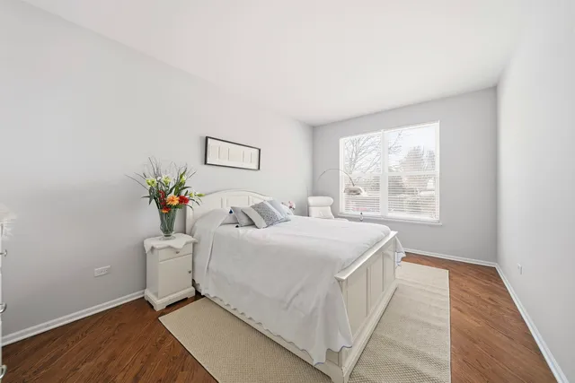 a bedroom with a bed and a potted plant