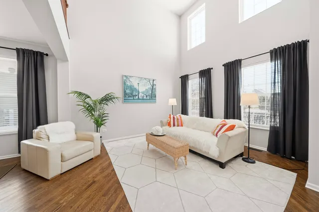 a living room with furniture and large windows