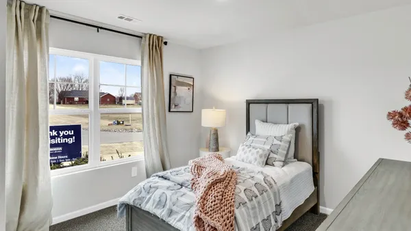 a bedroom with a bed and a mirror