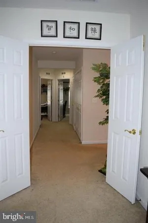 a view of a hallway with wooden shelves