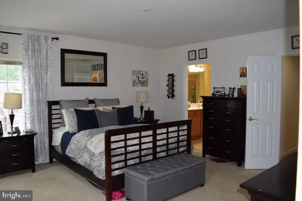 a bedroom with bed and a window