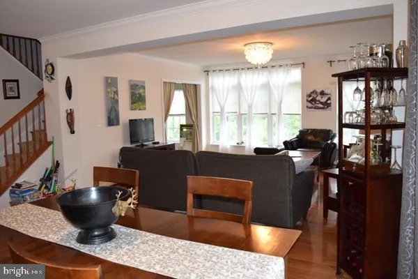 a living room with furniture a lamp and large window