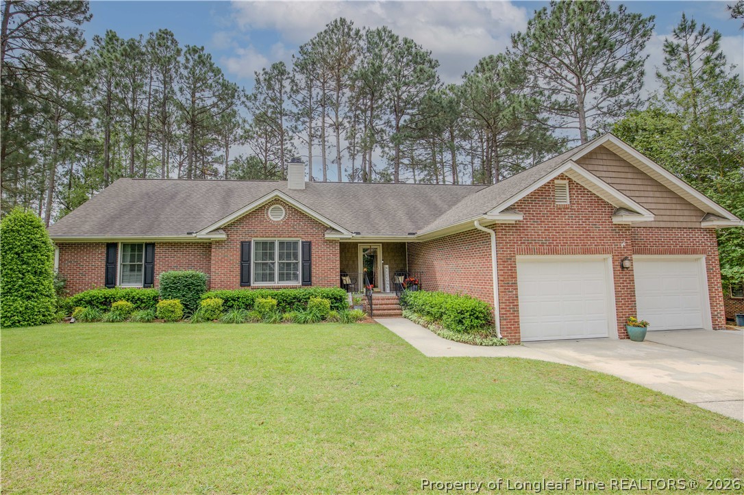 7815 Shuttle Road Fayetteville, NC 28311 - Photo 1 of 50 a front view of a house with garden
