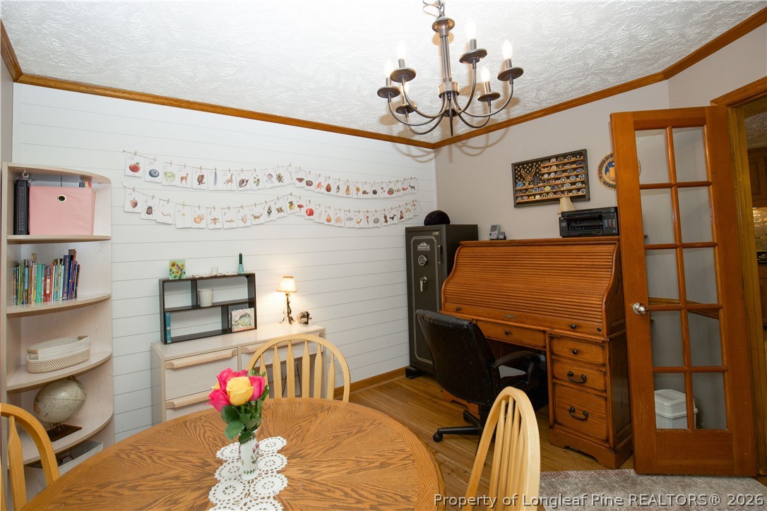 7815 Shuttle Road Fayetteville, NC 28311 - Photo 12 of 50 a bedroom with a bed and a chandelier