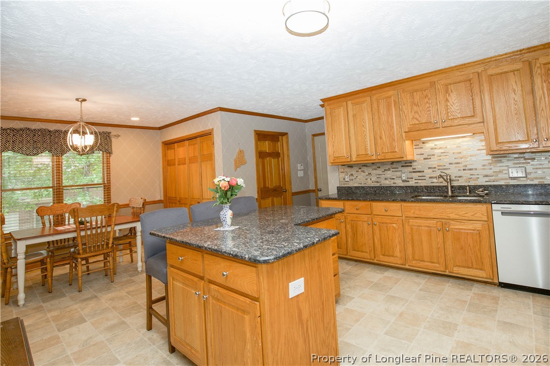 7815 Shuttle Road Fayetteville, NC 28311 - Photo 14 of 50 a kitchen with stainless steel appliances granite countertop sink and cabinets