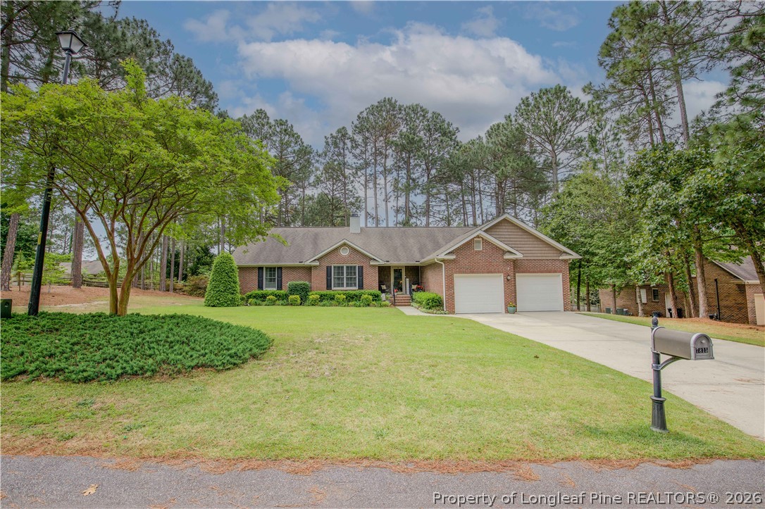 7815 Shuttle Road Fayetteville, NC 28311 - Photo 2 of 50 a front view of a house with a yard and trees