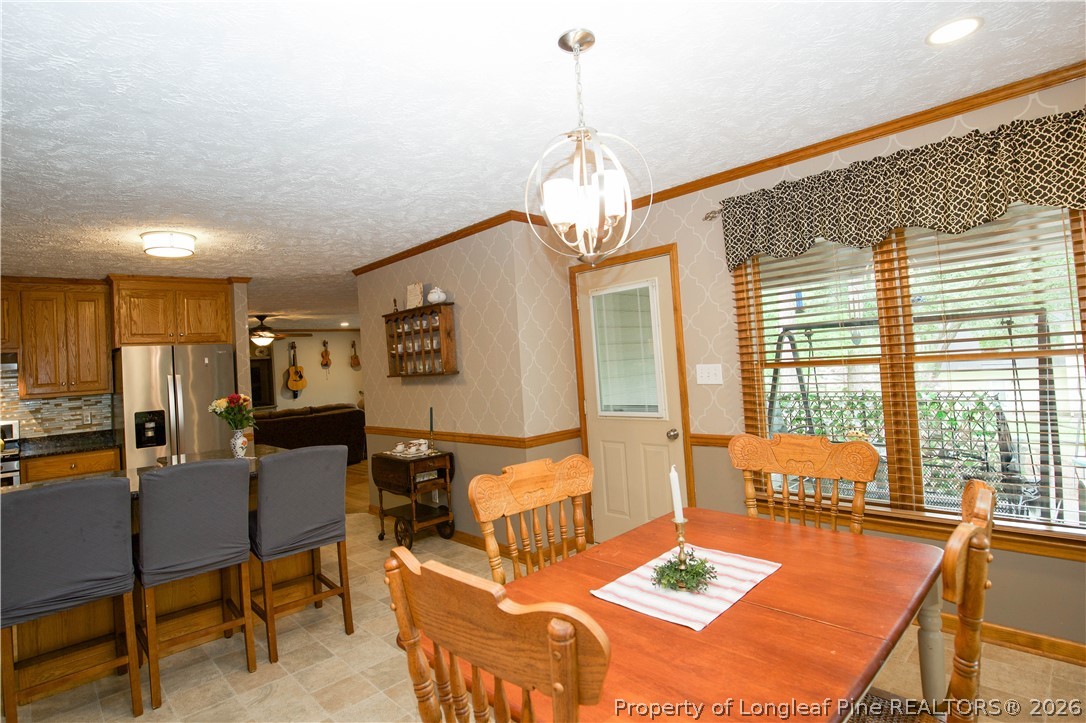 7815 Shuttle Road Fayetteville, NC 28311 - Photo 22 of 50 a living room with furniture and a chandelier