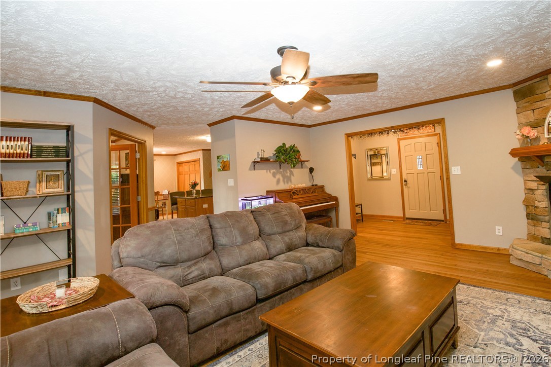 7815 Shuttle Road Fayetteville, NC 28311 - Photo 23 of 50 a living room with furniture a rug and a chandelier