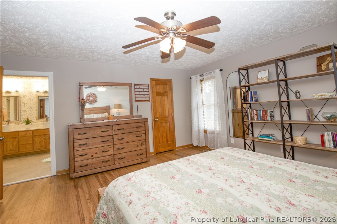 7815 Shuttle Road Fayetteville, NC 28311 - Photo 31 of 50 a bedroom with a bed and a dresser