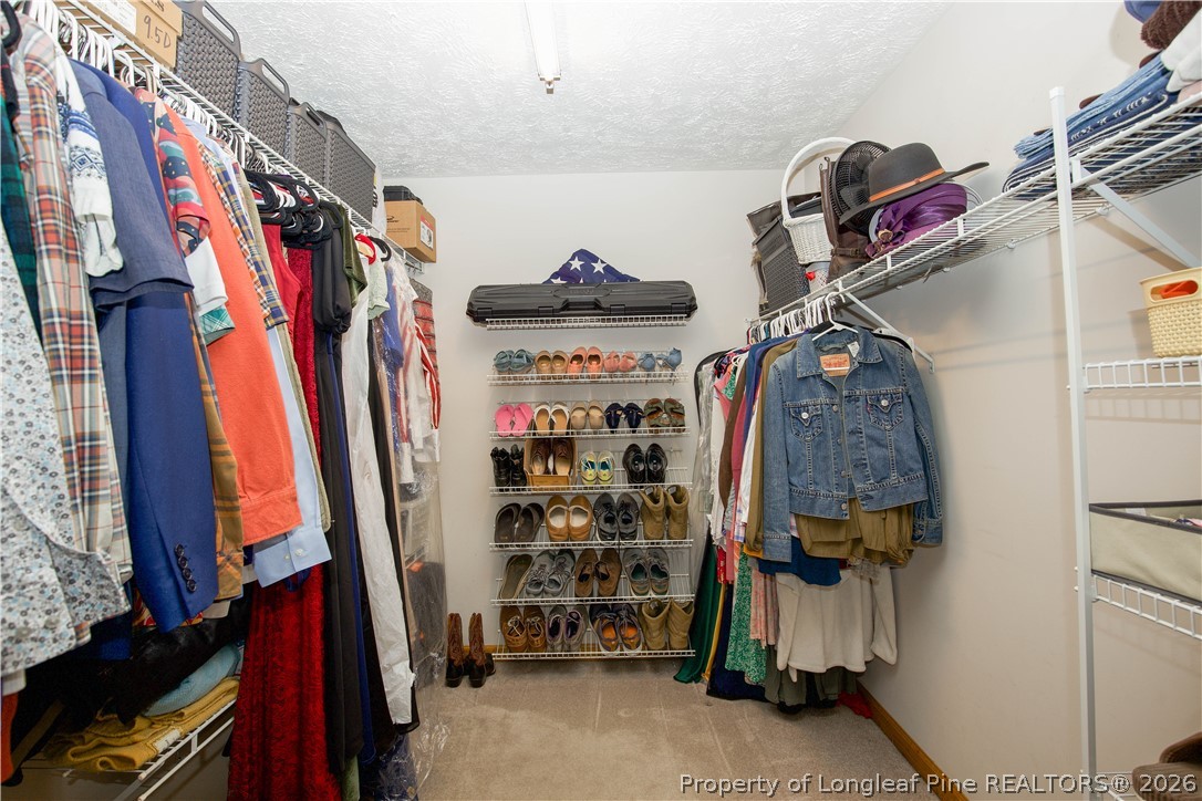 7815 Shuttle Road Fayetteville, NC 28311 - Photo 33 of 50 a view of walk in closet with clothes and shoes