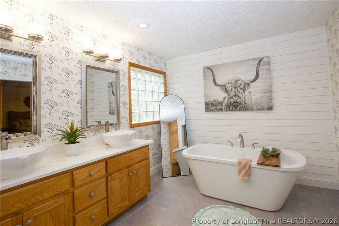 7815 Shuttle Road Fayetteville, NC 28311 - Photo 35 of 50 a bathroom with a sink and a bathtub