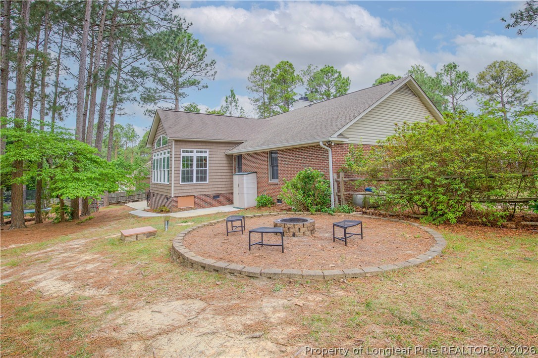 7815 Shuttle Road Fayetteville, NC 28311 - Photo 43 of 50 a view of patio with a table and chairs under an umbrella