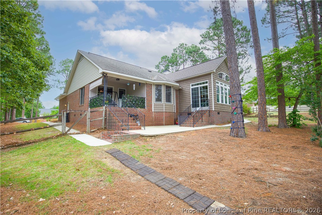 7815 Shuttle Road Fayetteville, NC 28311 - Photo 50 of 50 a view of a house with backyard and a tree