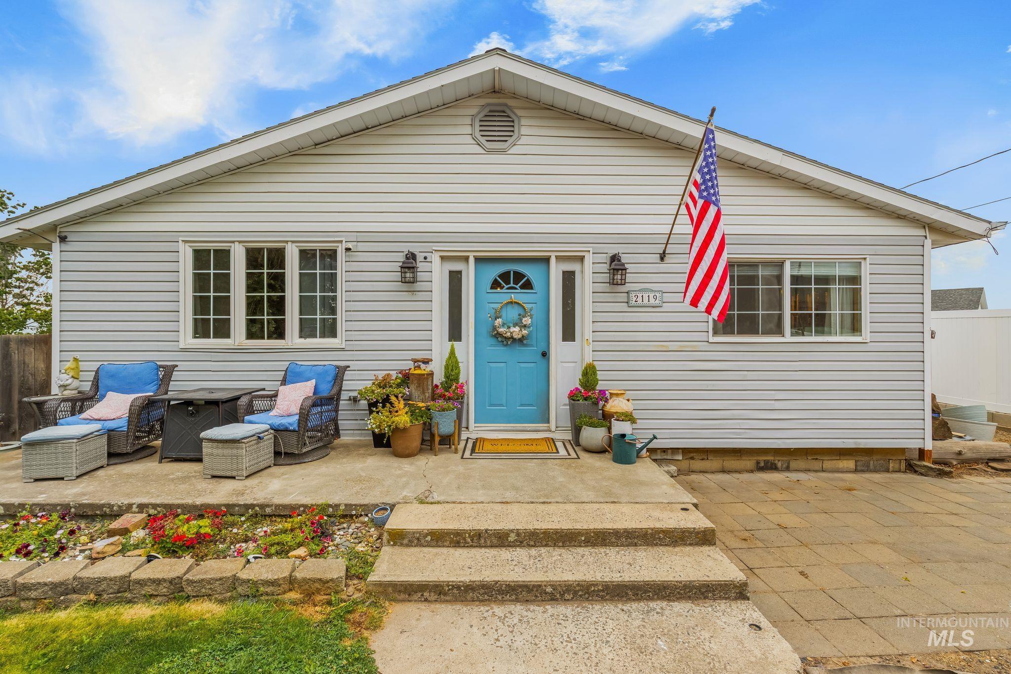 2119 Ripon Avenue Lewiston, ID 83501 - Photo 1 of 50 Light gray siding exterior with a bright blue entry door