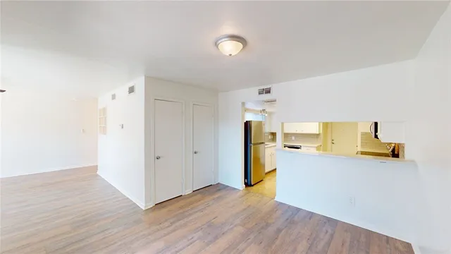 a view of a kitchen with wooden floor and a sink