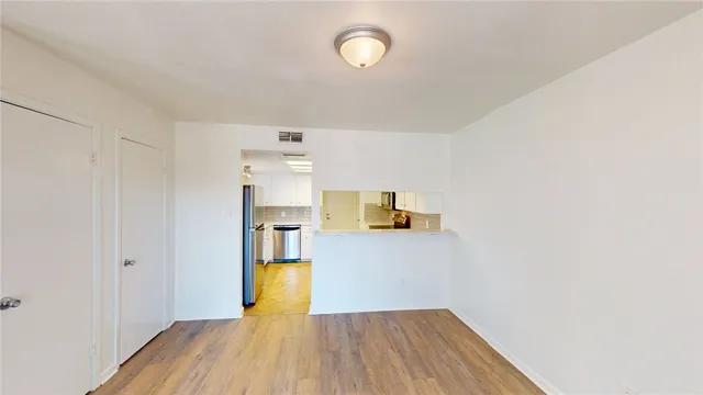 a view of a kitchen with wooden floor