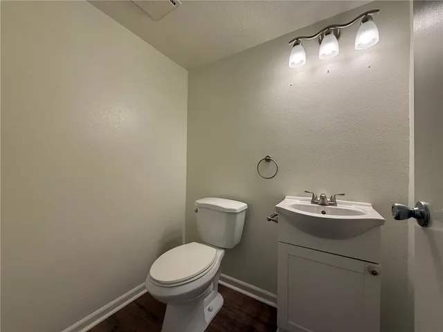 a bathroom with a sink mirror and toilet