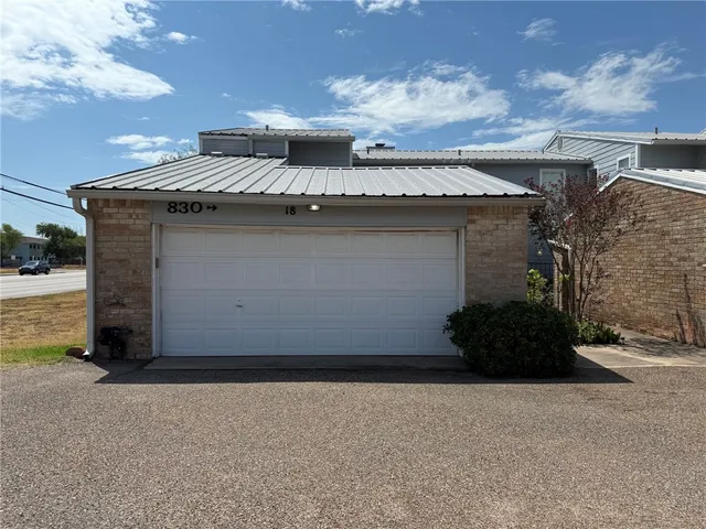 a view of a house with a yard and garage