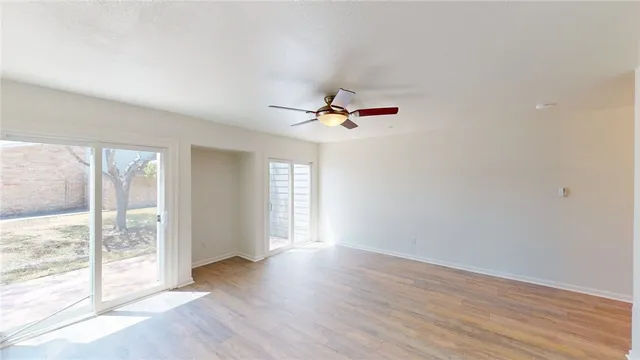 wooden floor in an empty room with a window