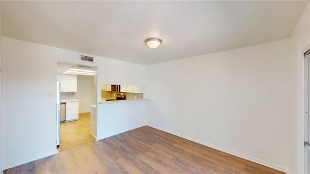a view of a kitchen with wooden floor and a sink