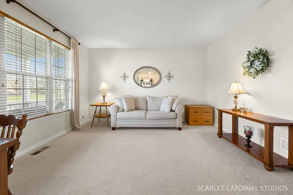 a kitchen with stainless steel appliances granite countertop a refrigerator a stove and a sink with wooden floor