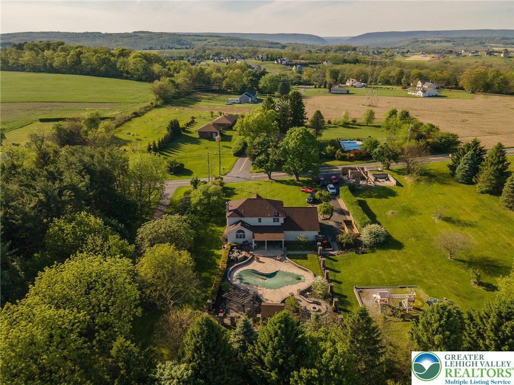 2170 Clearview Road Coplay, PA 18037 - Photo 70 of 75 This expansive estate features a captivating pool, offering serene outdoor living amidst lush greenery.