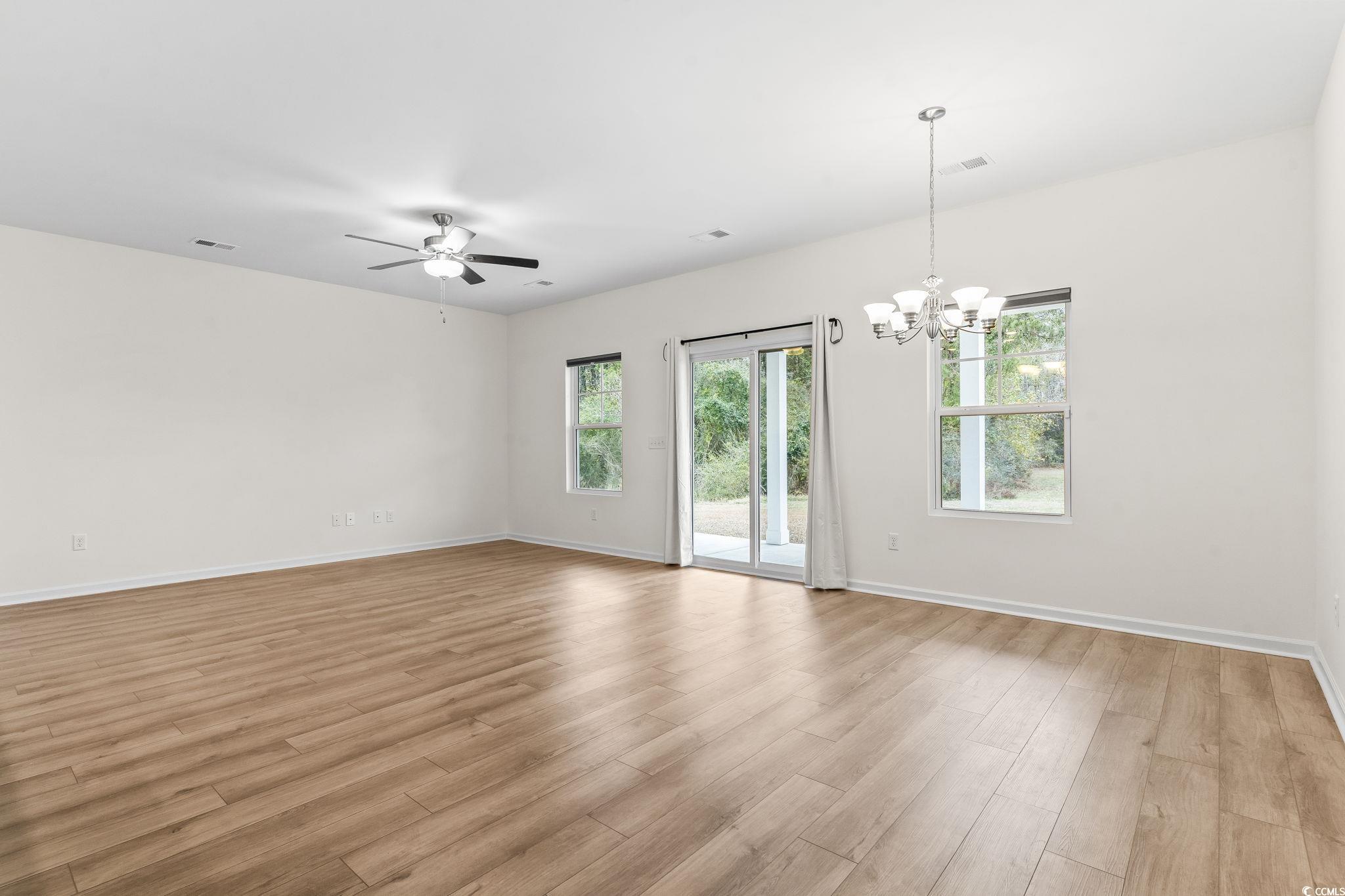 4115 Highway 19 Conway, SC 29526 - Photo 11 of 40 Spacious living room with an open layout, neutral colors, and seamless flow into the kitchen and dining areas.