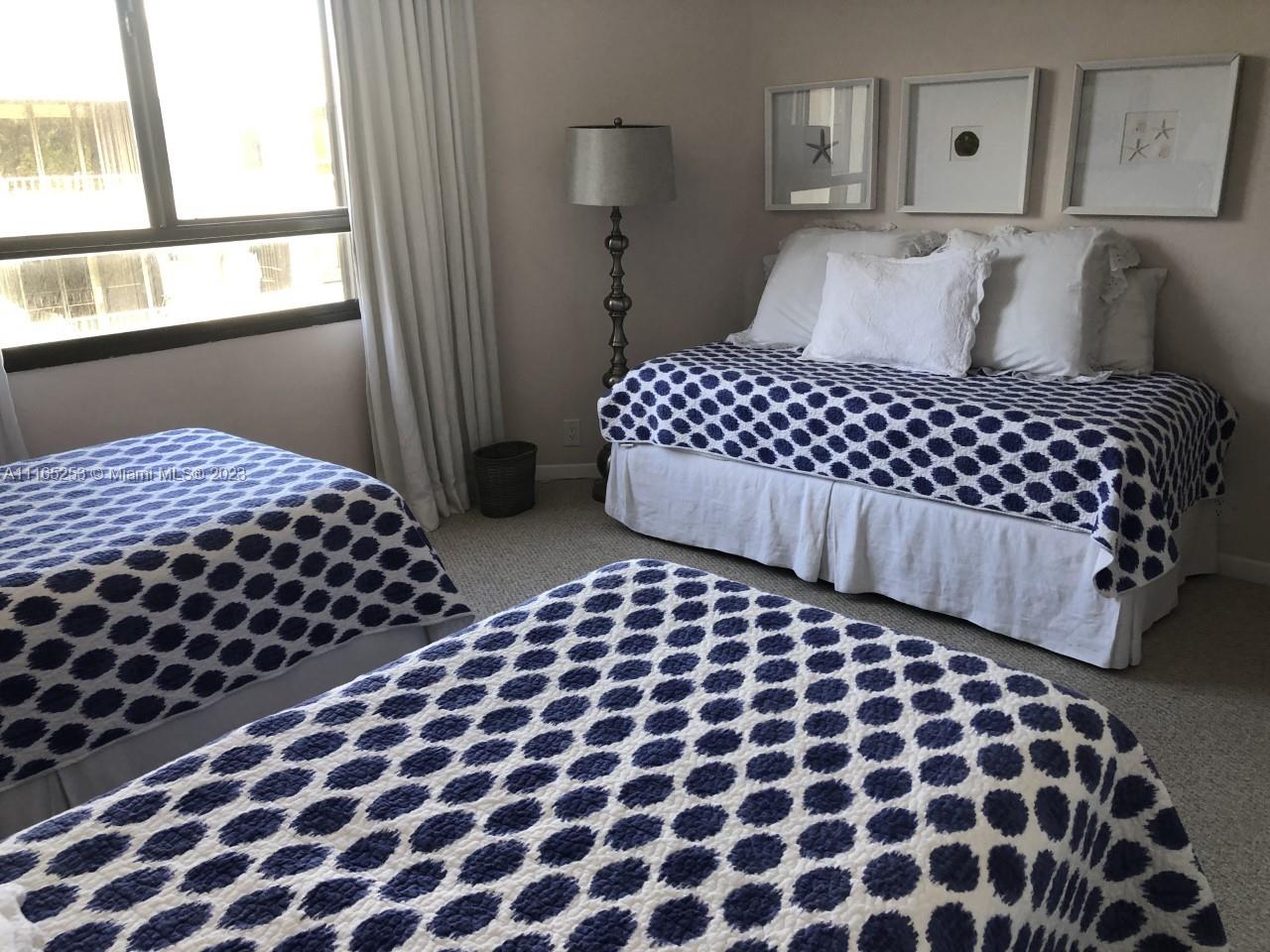 101 Crandon Boulevard, Unit 473 Key Biscayne, FL 33149 - Photo 12 of 24 a bedroom with a bed and wooden floor