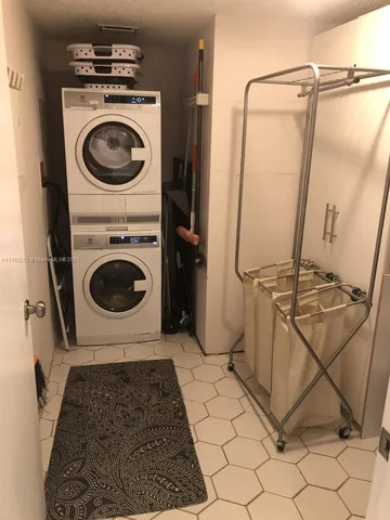 a bathroom with a washing machine and a rug