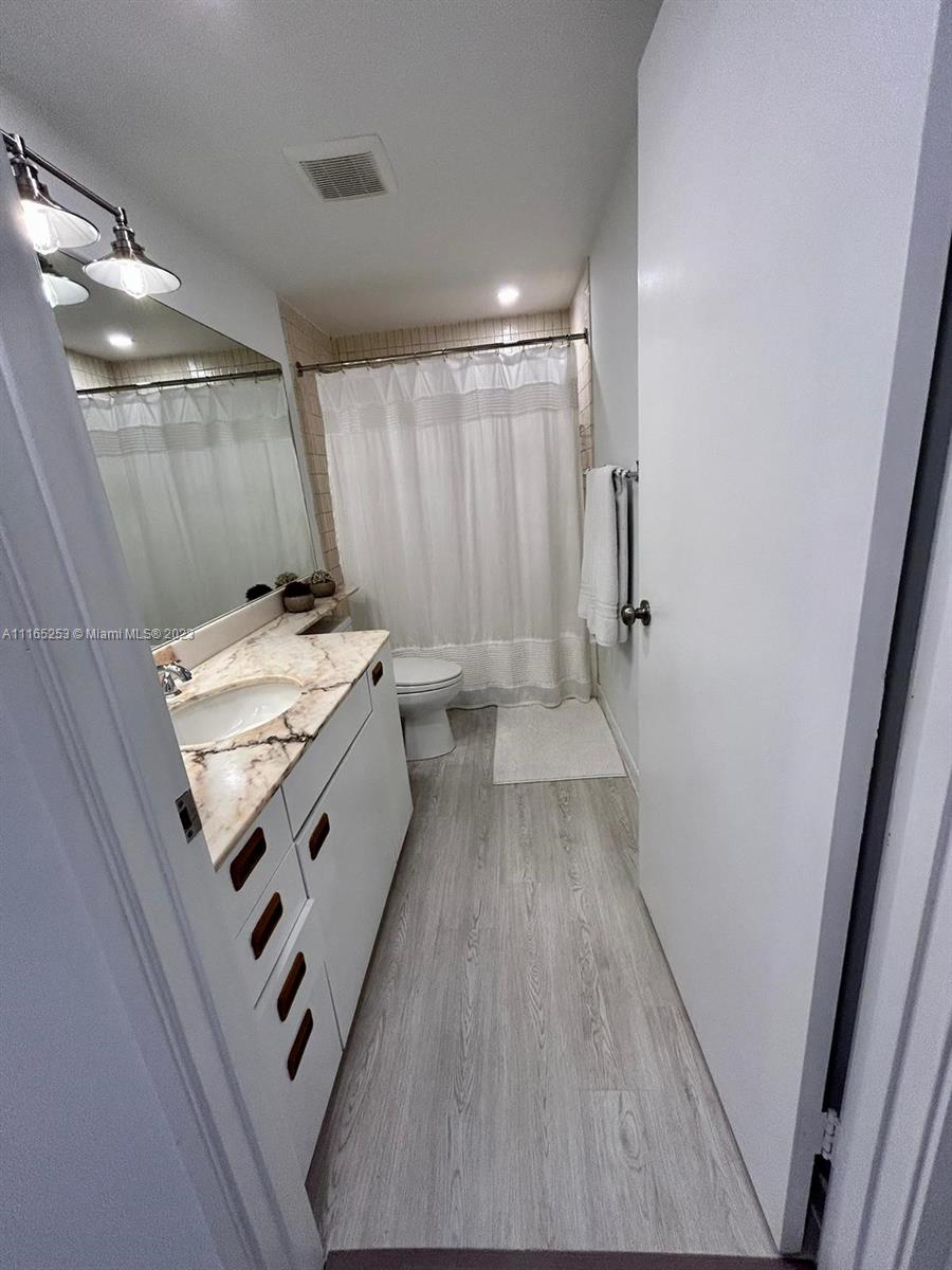 101 Crandon Boulevard, Unit 473 Key Biscayne, FL 33149 - Photo 16 of 24 a bathroom with a sink a toilet and shower