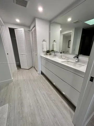 a bathroom with a double vanity sink and mirror