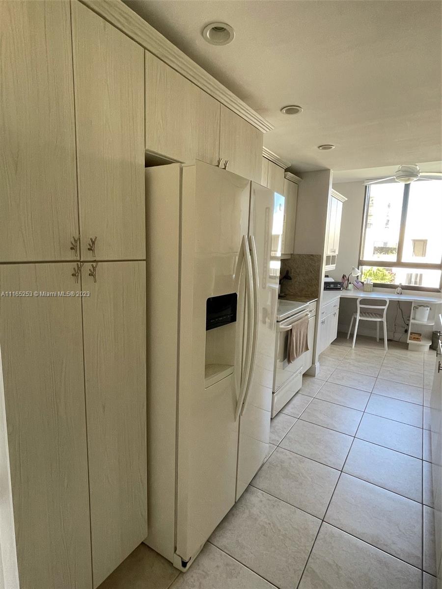 101 Crandon Boulevard, Unit 473 Key Biscayne, FL 33149 - Photo 2 of 24 a kitchen with stainless steel appliances a refrigerator and cabinets