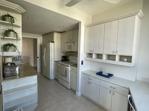 a kitchen with stainless steel appliances a sink and cabinets