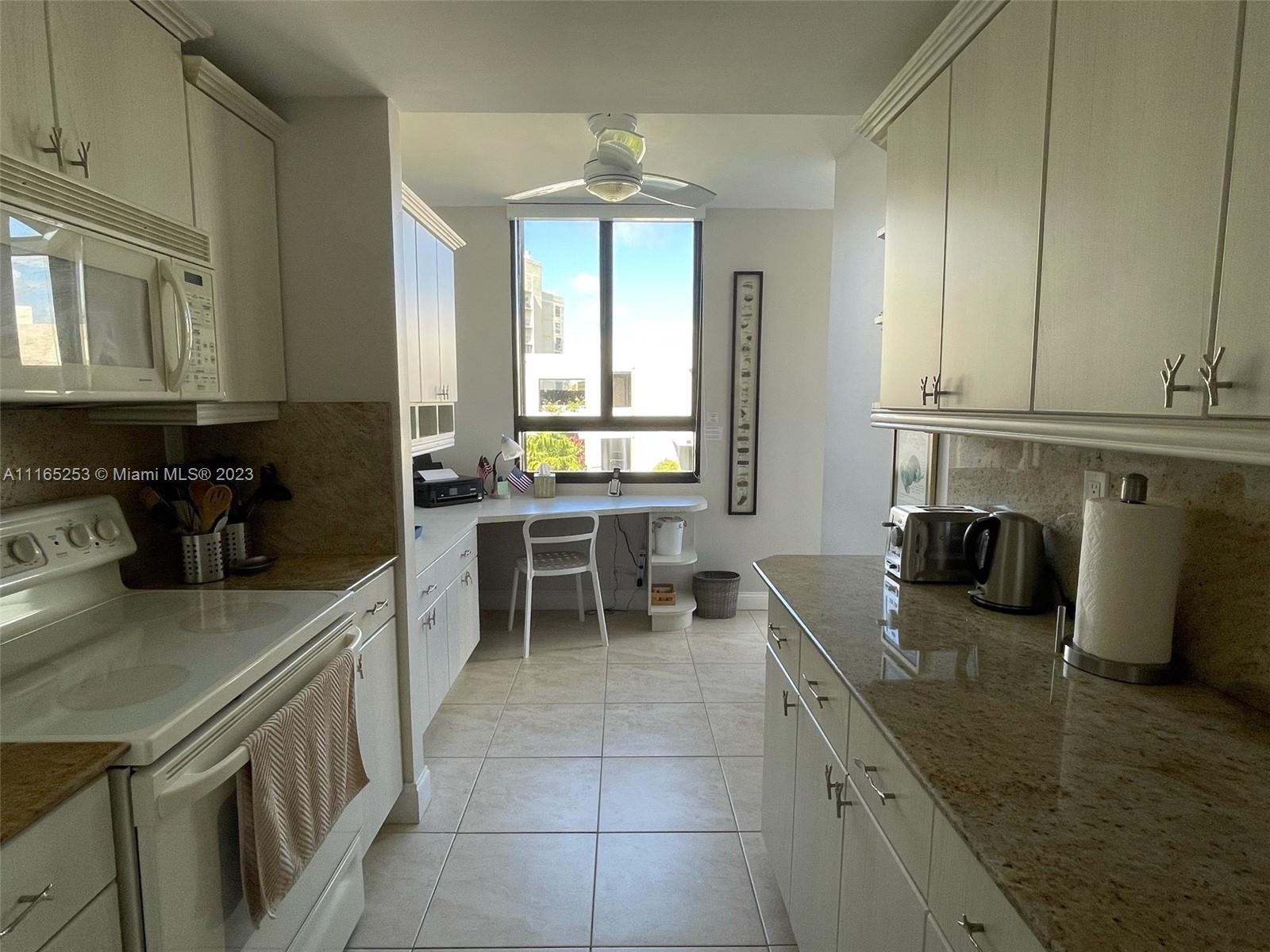 101 Crandon Boulevard, Unit 473 Key Biscayne, FL 33149 - Photo 6 of 24 a kitchen with stainless steel appliances granite countertop a sink a stove counter space and cabinets
