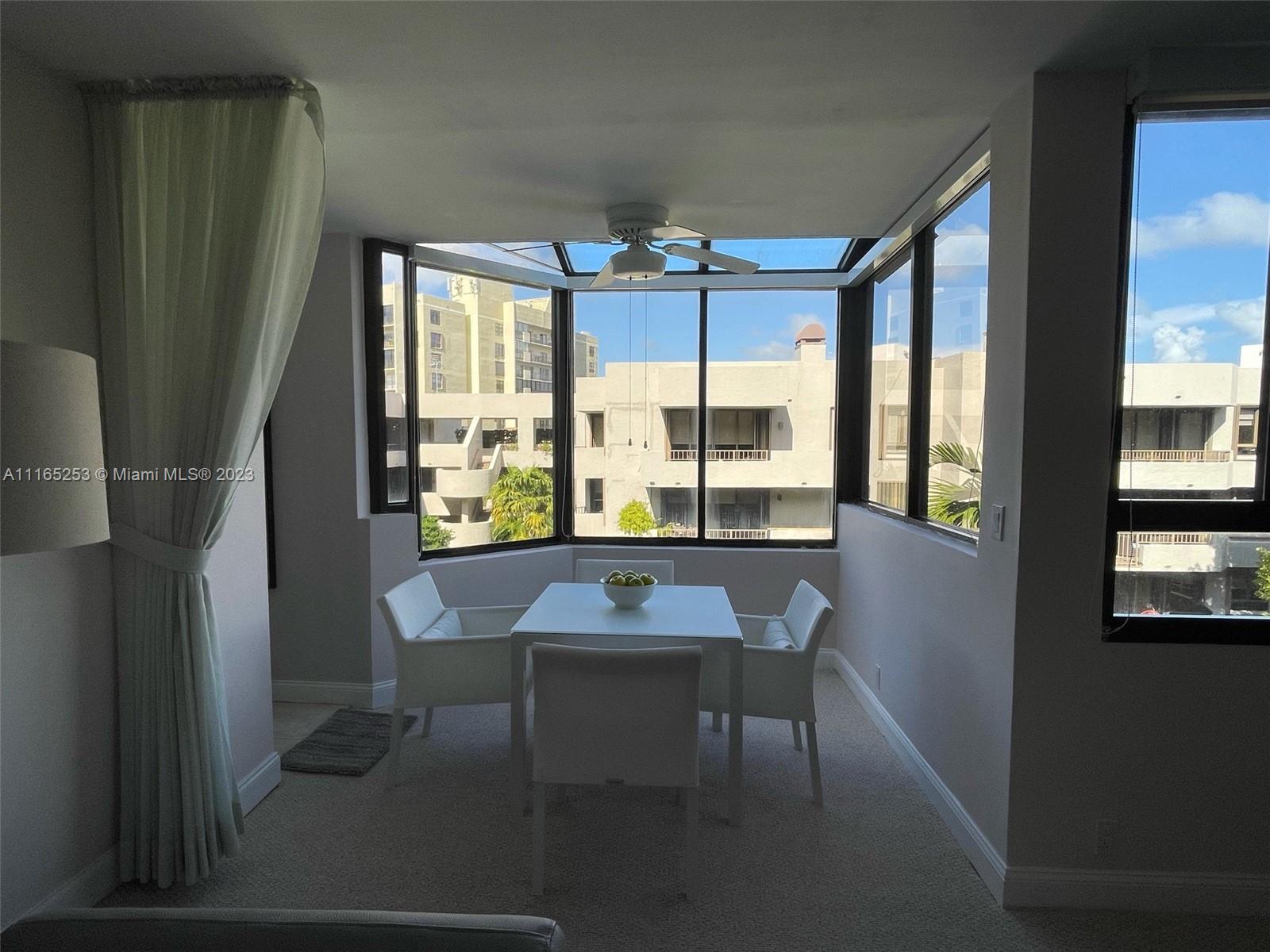 101 Crandon Boulevard, Unit 473 Key Biscayne, FL 33149 - Photo 8 of 24 a view of a dining room with furniture and a window