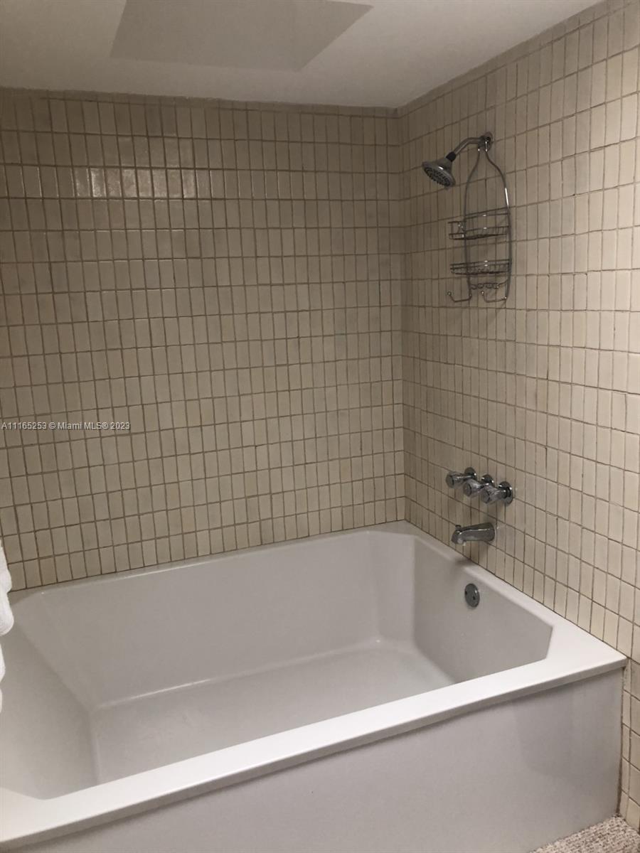 101 Crandon Boulevard, Unit 473 Key Biscayne, FL 33149 - Photo 10 of 24 a bathroom with a bathtub