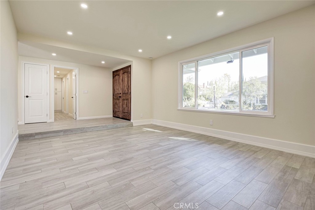 11369 Darby Avenue Porter Ranch, CA 91326 - Photo 11 of 56 an empty room with wooden floor and windows