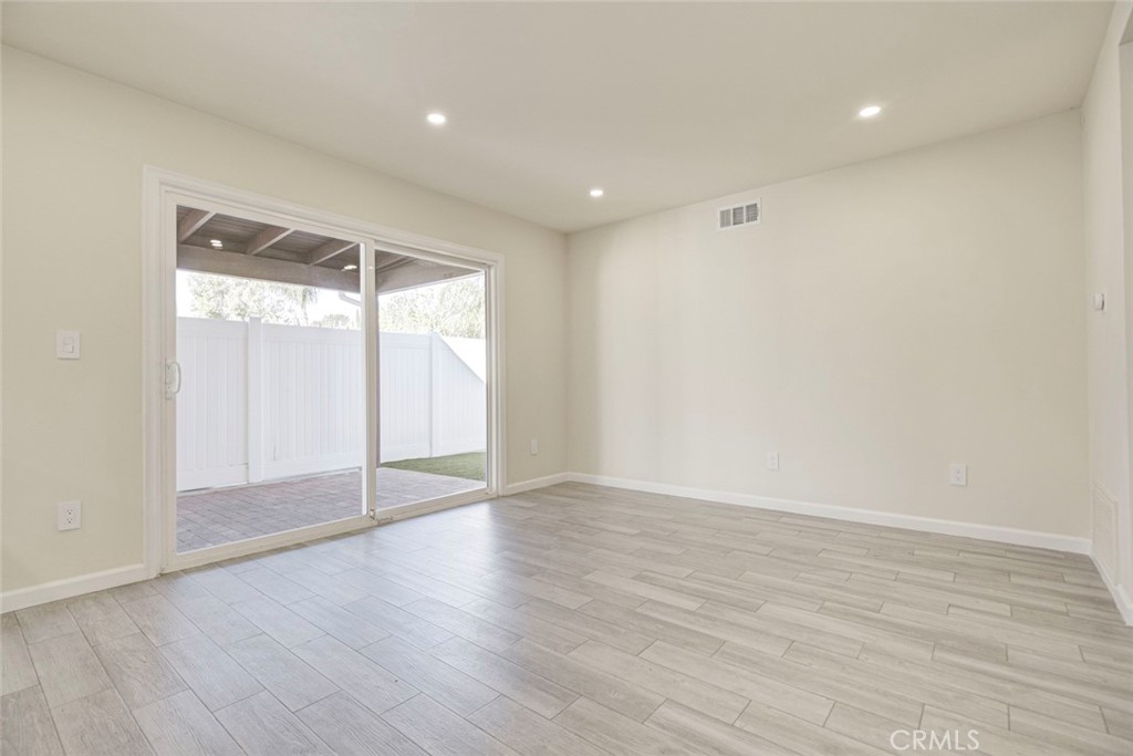 11369 Darby Avenue Porter Ranch, CA 91326 - Photo 13 of 56 a view of an empty room with wooden floor and a window