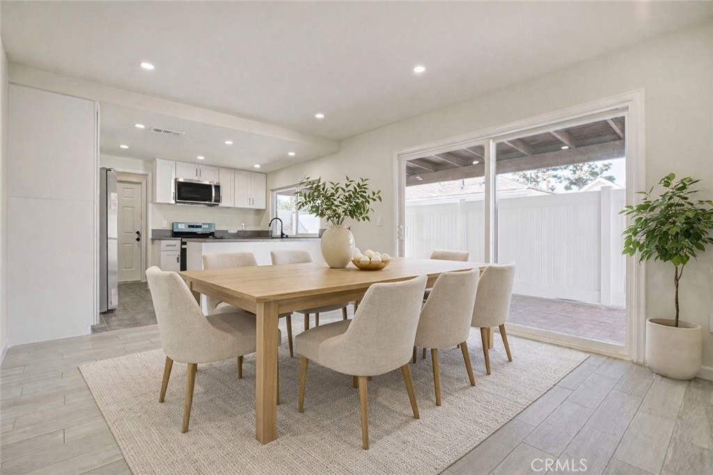 11369 Darby Avenue Porter Ranch, CA 91326 - Photo 14 of 56 a view of a dining room with furniture and a potted plant