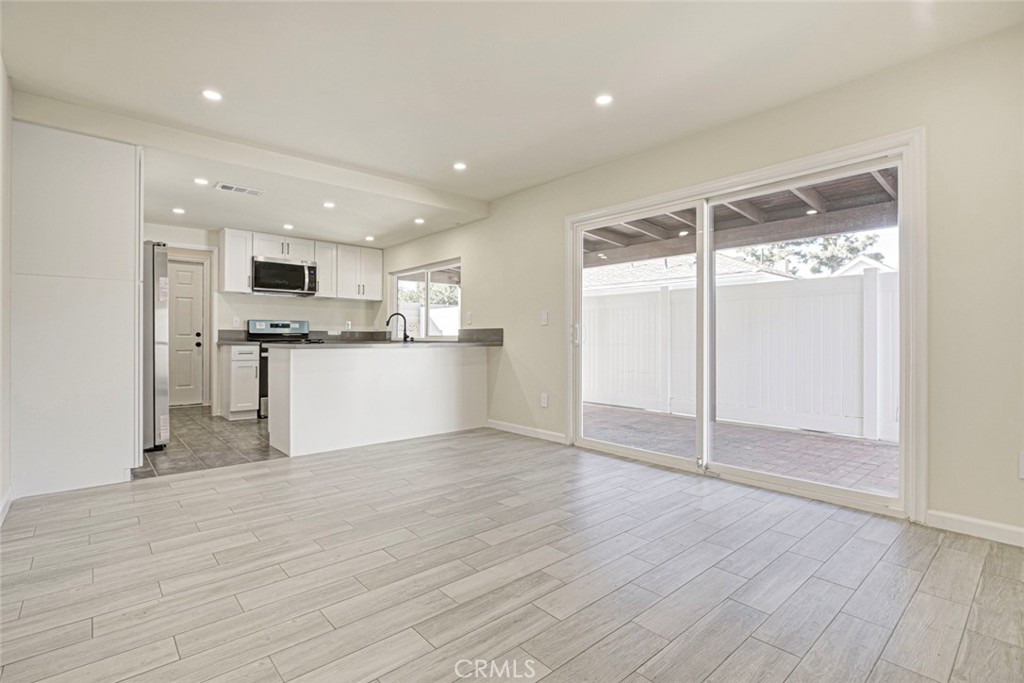 11369 Darby Avenue Porter Ranch, CA 91326 - Photo 15 of 56 a view of a kitchen with a sink and a refrigerator