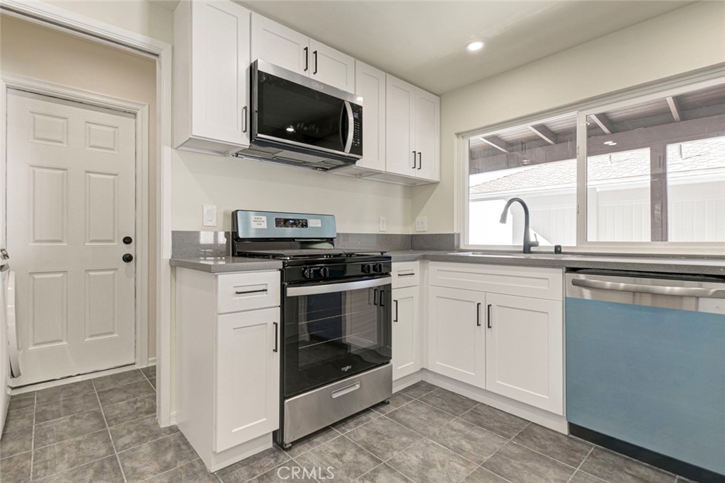 11369 Darby Avenue Porter Ranch, CA 91326 - Photo 17 of 56 a kitchen with a sink stove and microwave