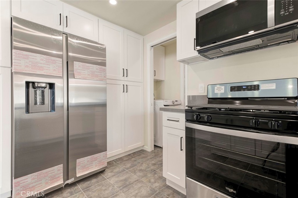 11369 Darby Avenue Porter Ranch, CA 91326 - Photo 18 of 56 a kitchen with stainless steel appliances and view of the refrigerator